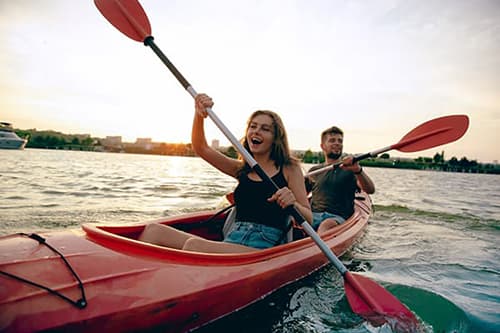 Happy couple kayaking on a lake