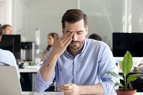 Man suffering from dry eye syndrome