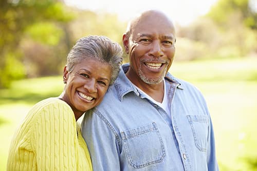 Older couple smiling after glaucoma surgery