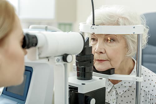 Older woman being examined for cataracts