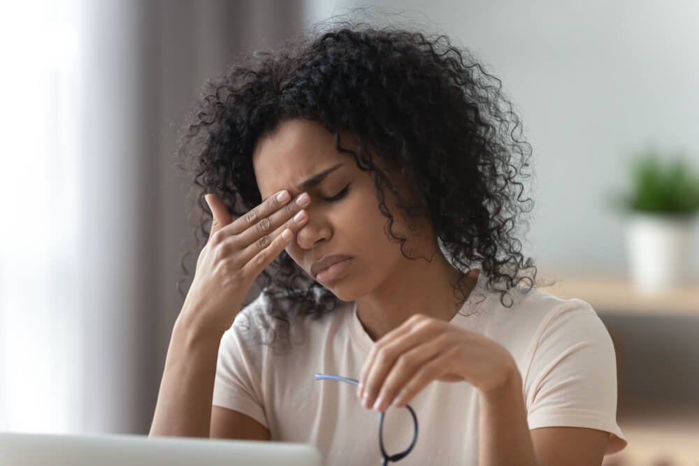 woman wiping forehead