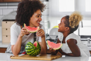 woman and child eating watermelon