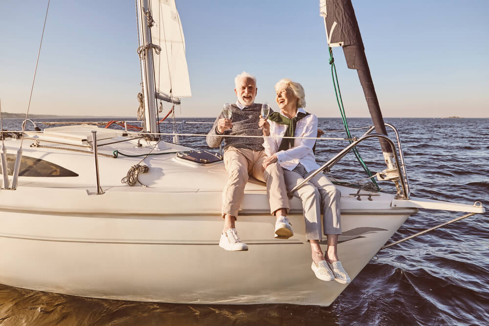 Older couple drinking champagne on a boat