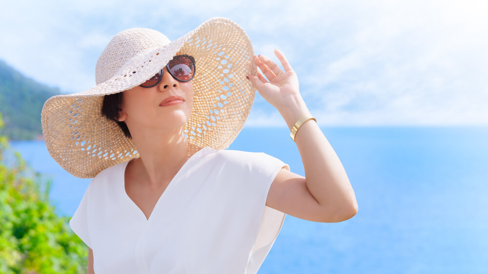 woman out in the sun with hat on
