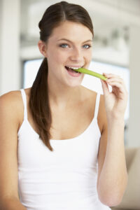 woman eating celery