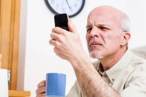 Older man looking at his phone