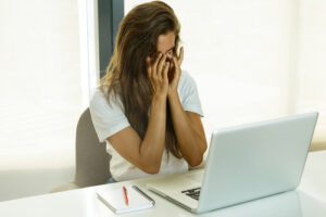 woman suffering from eye strain at computer